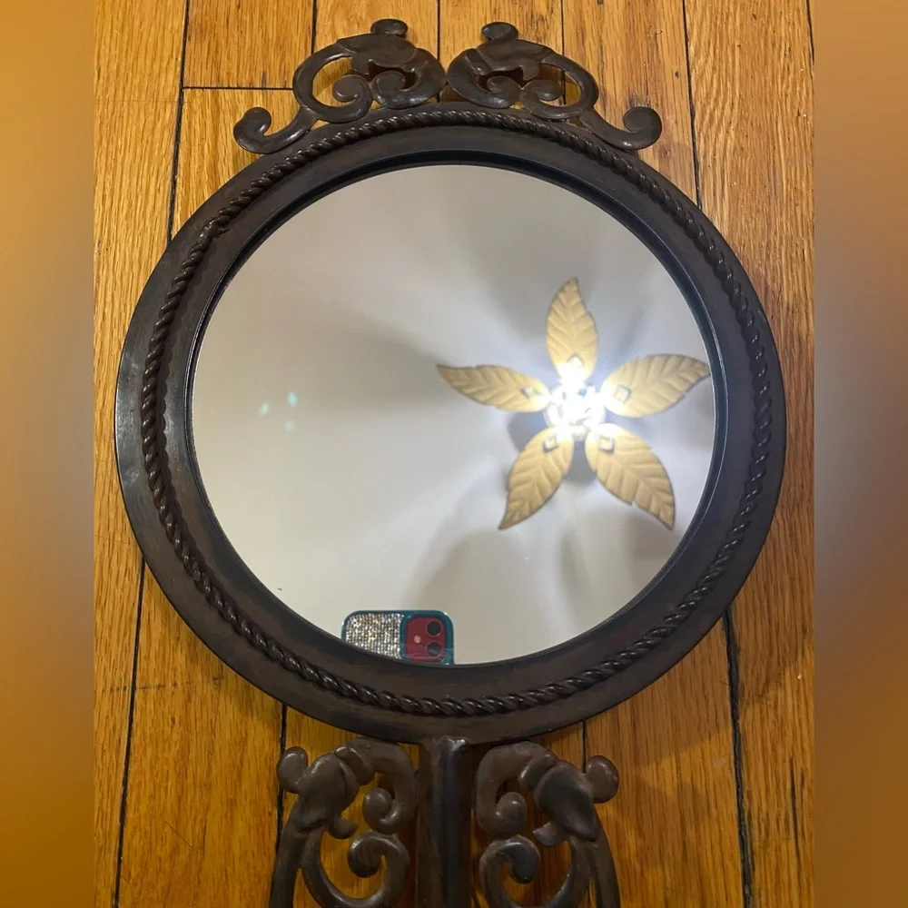 Vintage, ornate mirror with wooden backing